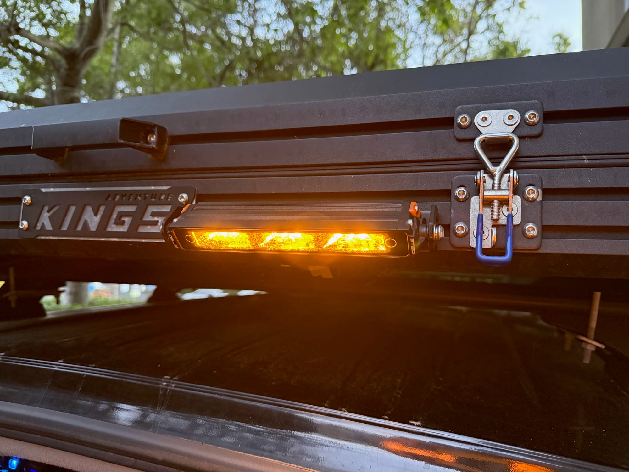 The amber light glowing on the side of the Kings rooftop tent in the late afternoon