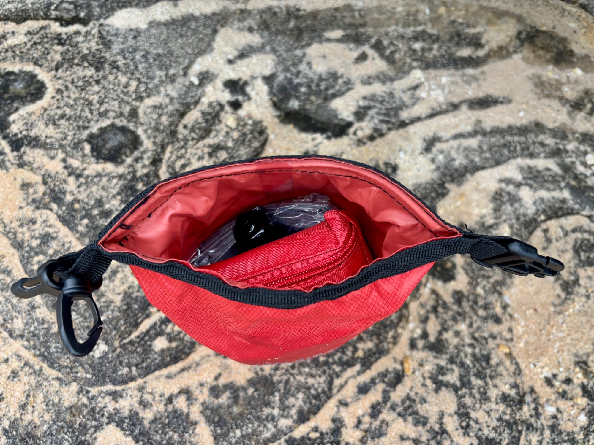 The red first aid dry bag opened at the top
