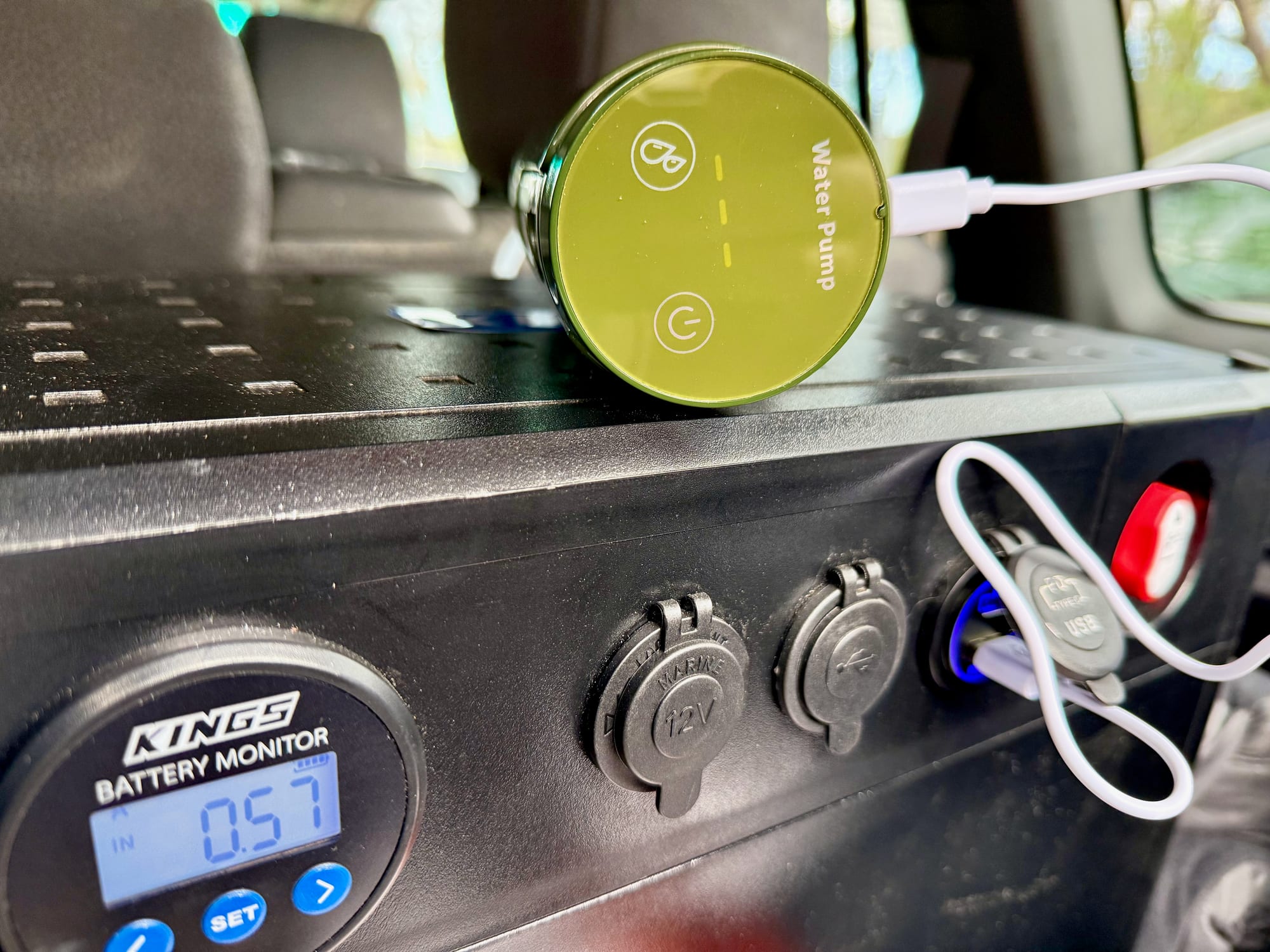 The pump charging on a USB cable from the panel in the back of a 4WD