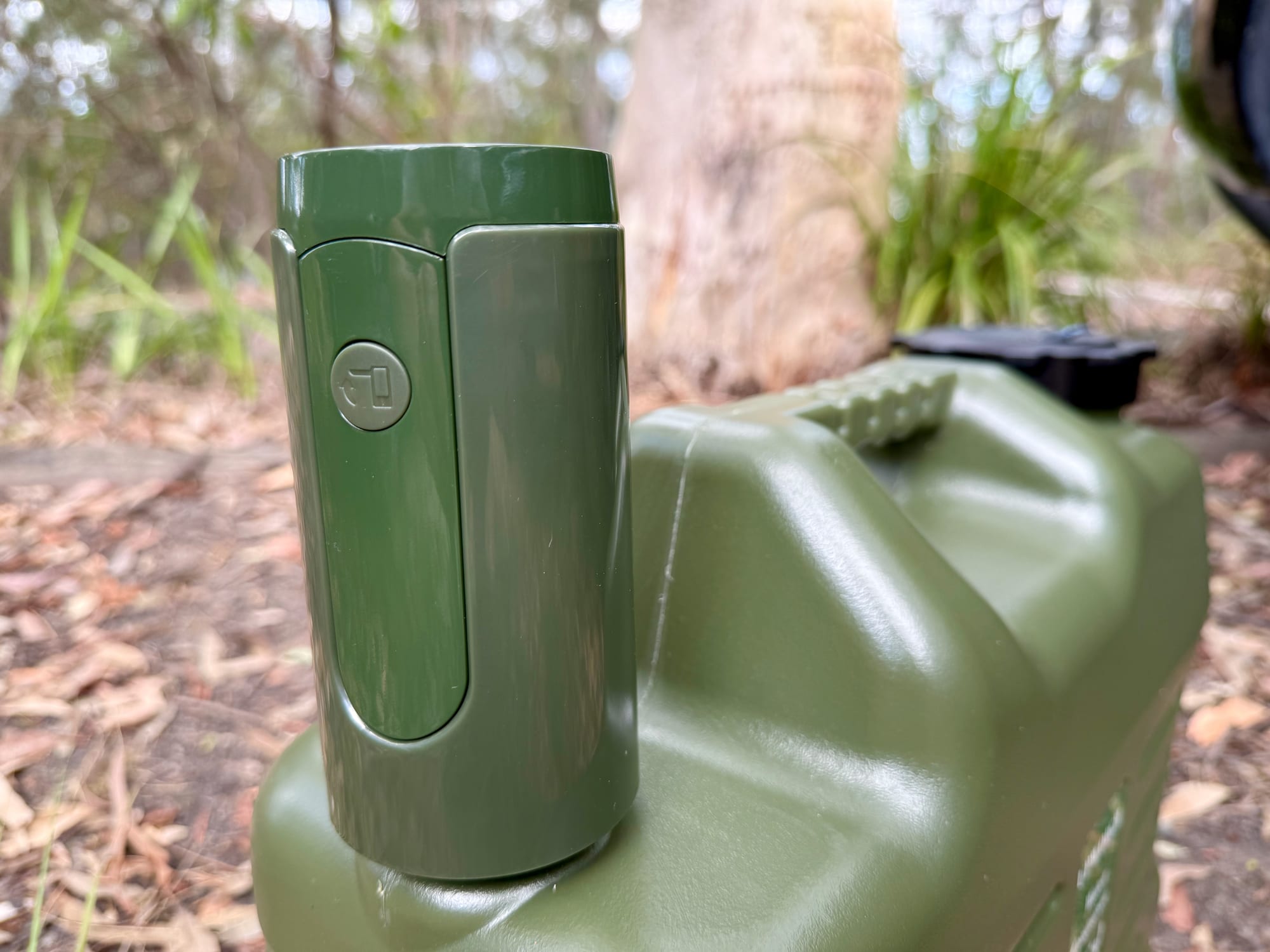 Close-up of the green pump sitting on top of the container