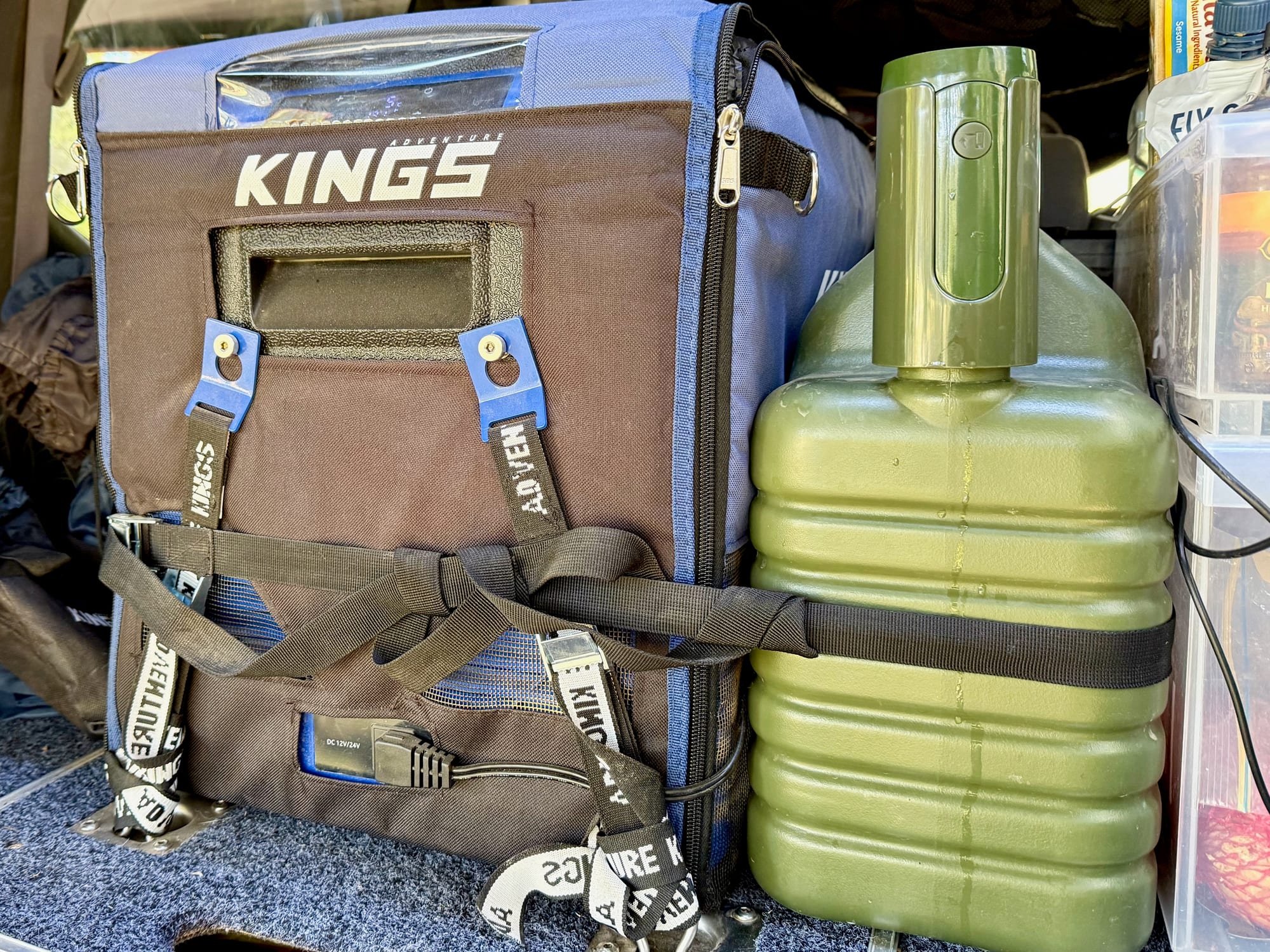 The Upwoigh container strapped to a Kings fridge in the back of a 4WD, with the pump on top