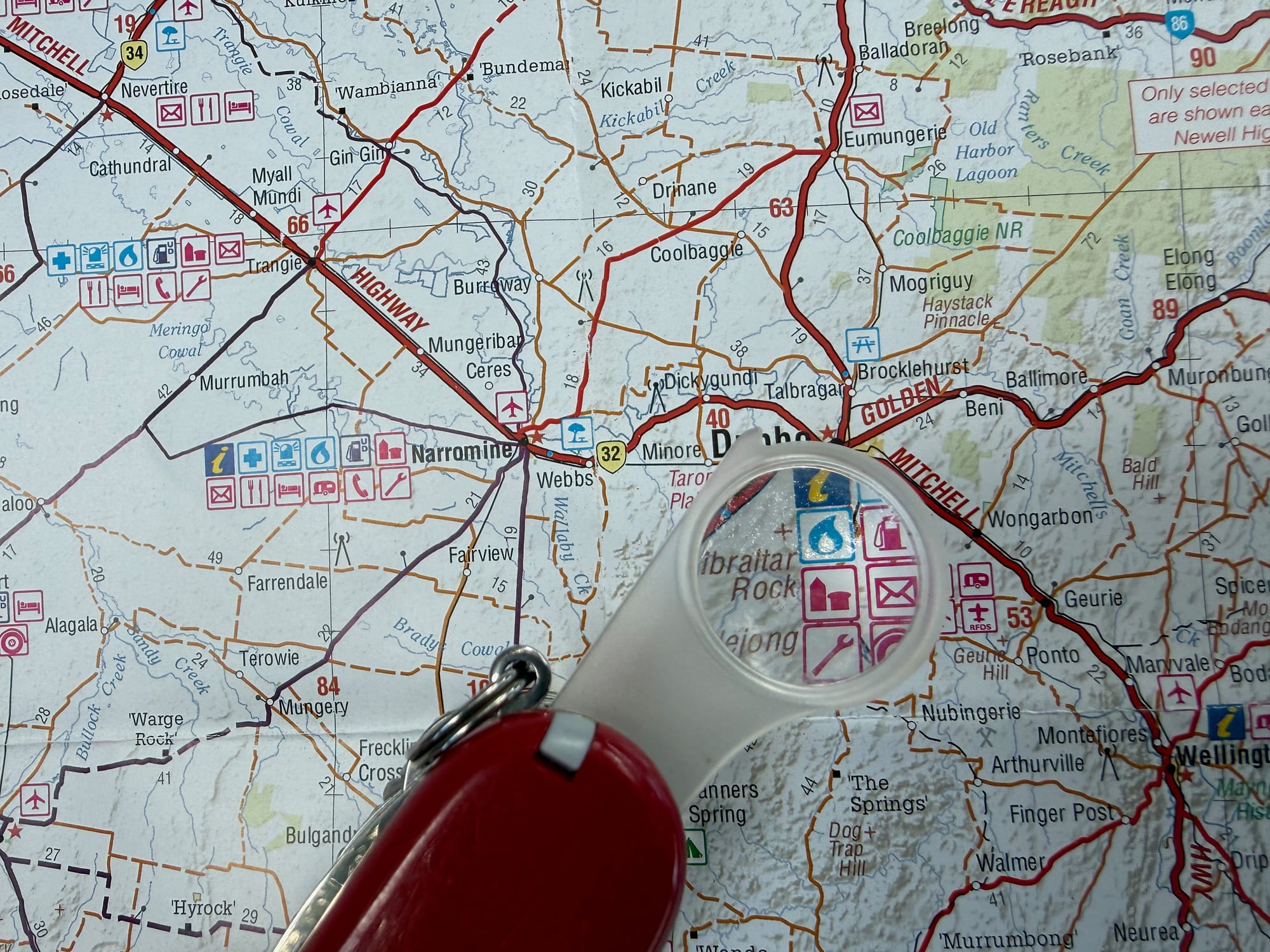 The SwissChamp’s magnifier over the symbols on a Hema map of outback New South Wales