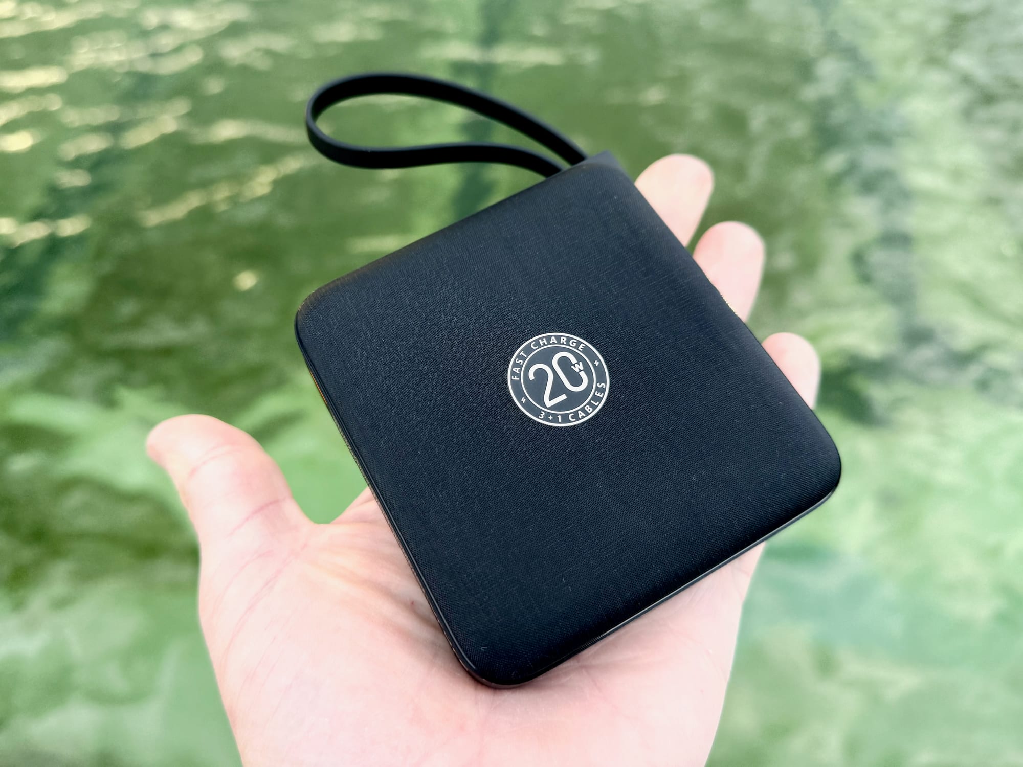 The VRURC 20,000mAh power bank lying in the palm of a hand