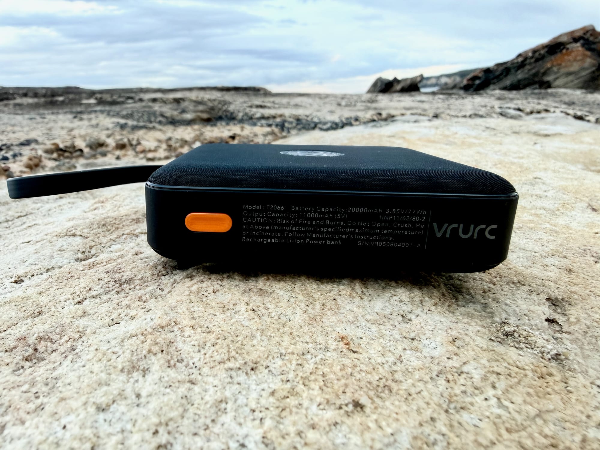 The label on the side of the VRURC power bank: model T2066, 20000mAh, 77Wh, with the orange button