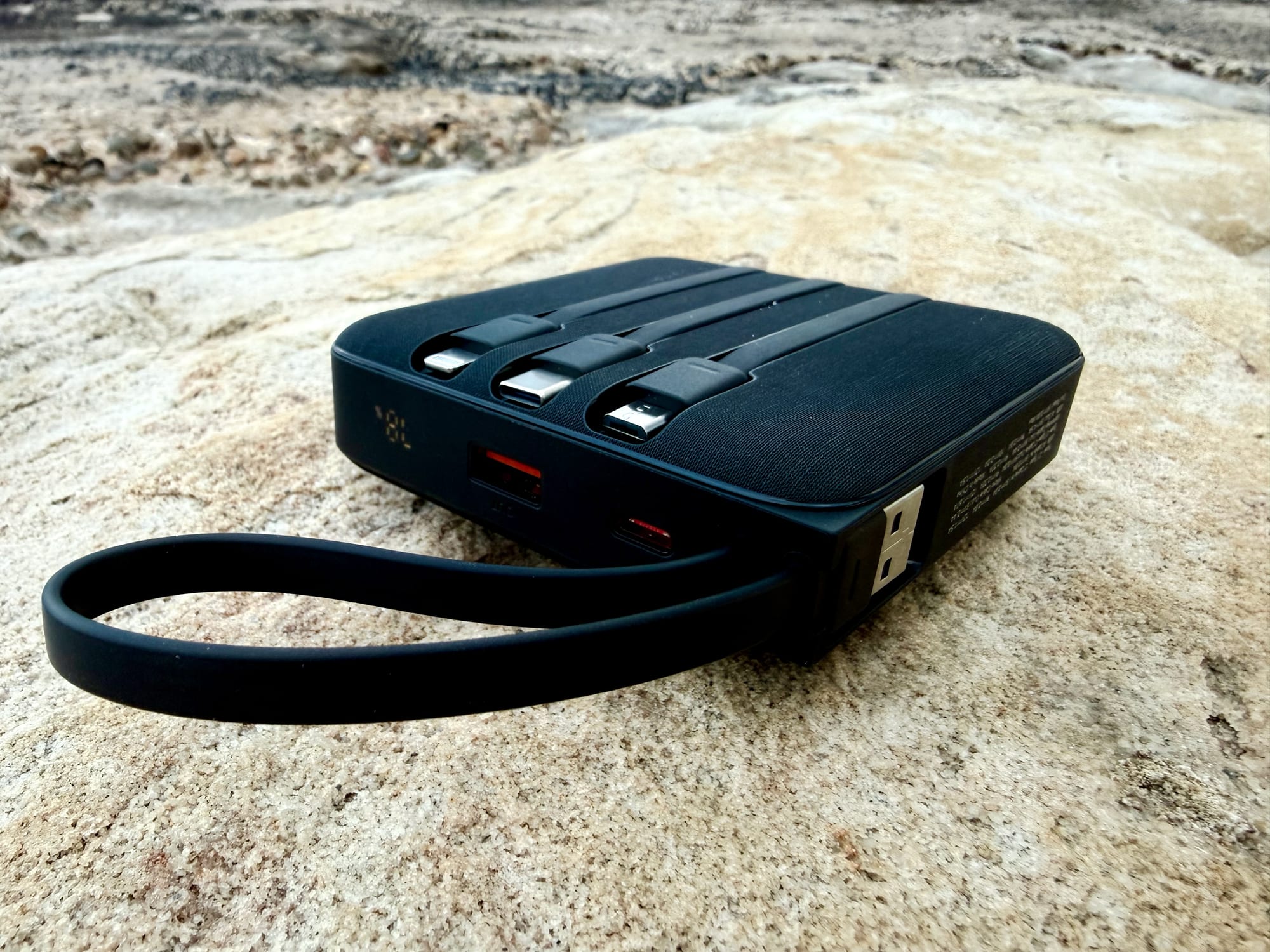The USB-A recharging cable looping out from the side of the VRURC power bank