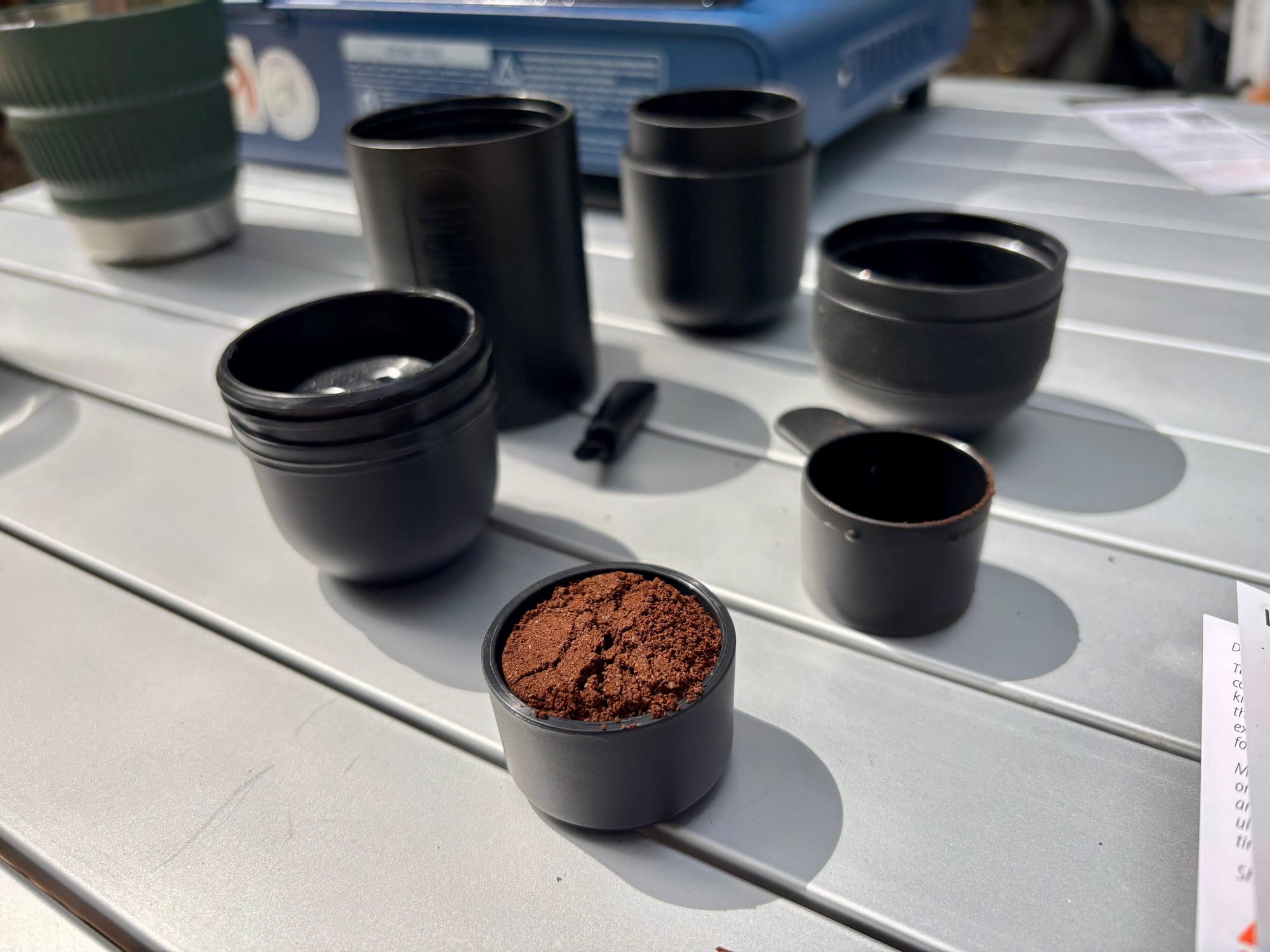The filter basket of the Minipresso GR filled with ground coffee