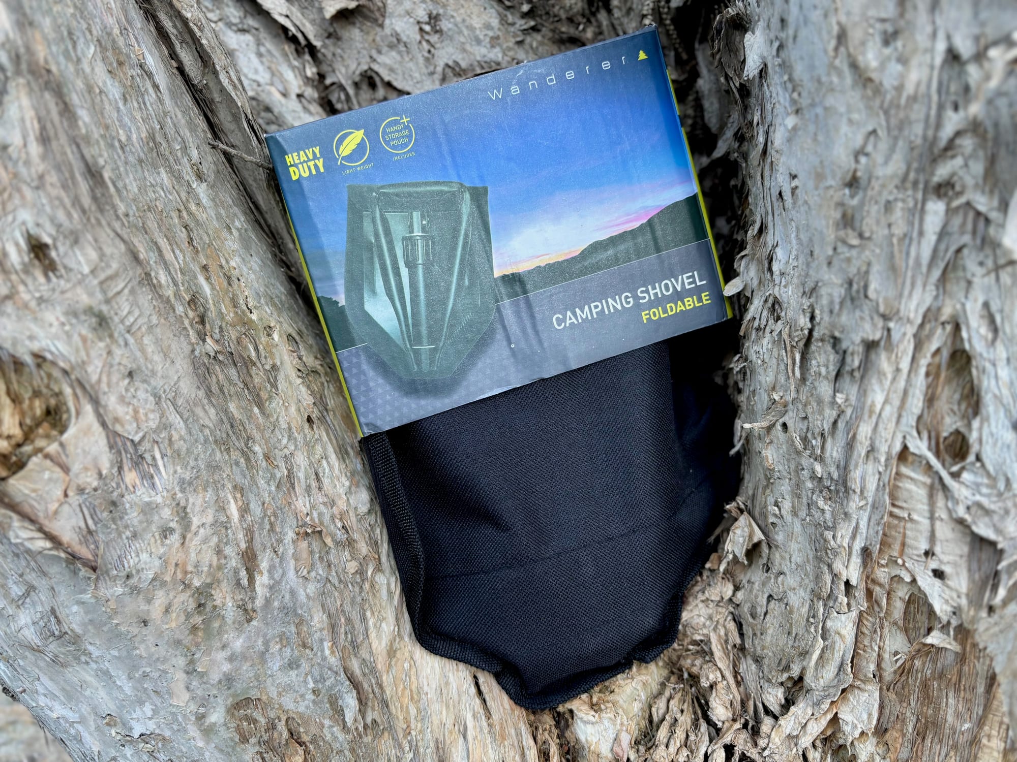 The Wanderer Camping Shovel box lying on top of its black storage pouch
