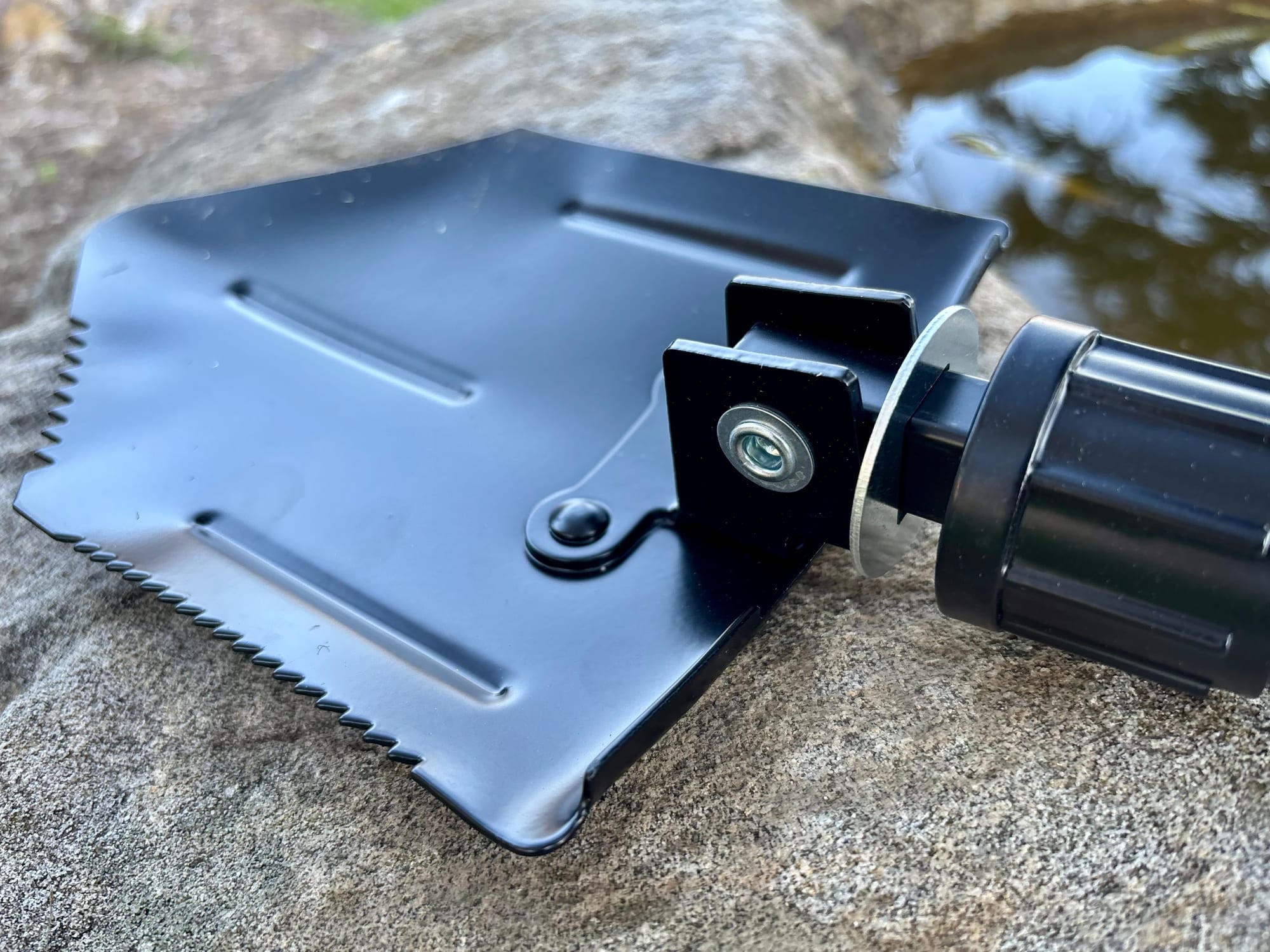 The black steel blade of the Wanderer shovel, with the serrated edge along one side