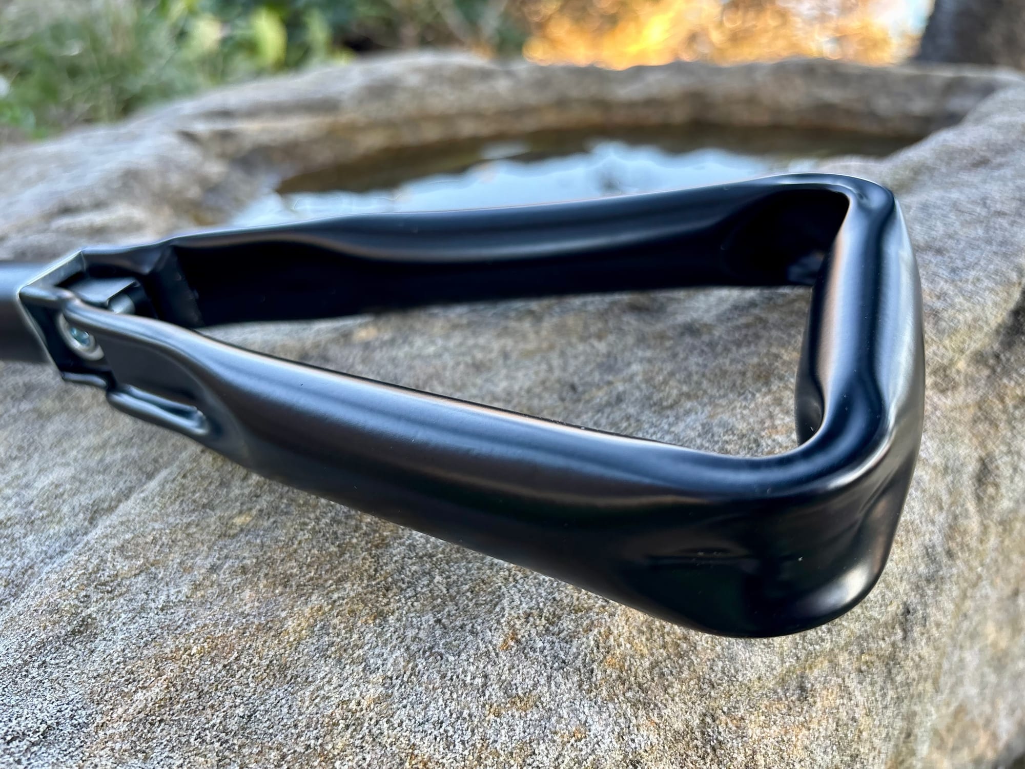 The steel triangle handle of the Wanderer Foldable Camp Shovel