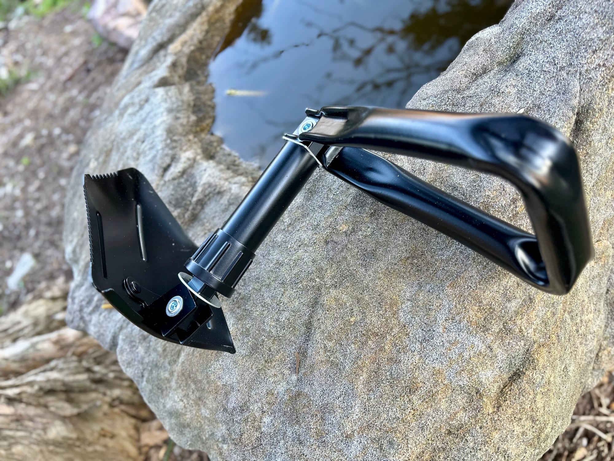 The Wanderer shovel partly unfolded, with the blade and handle swinging out from the shaft