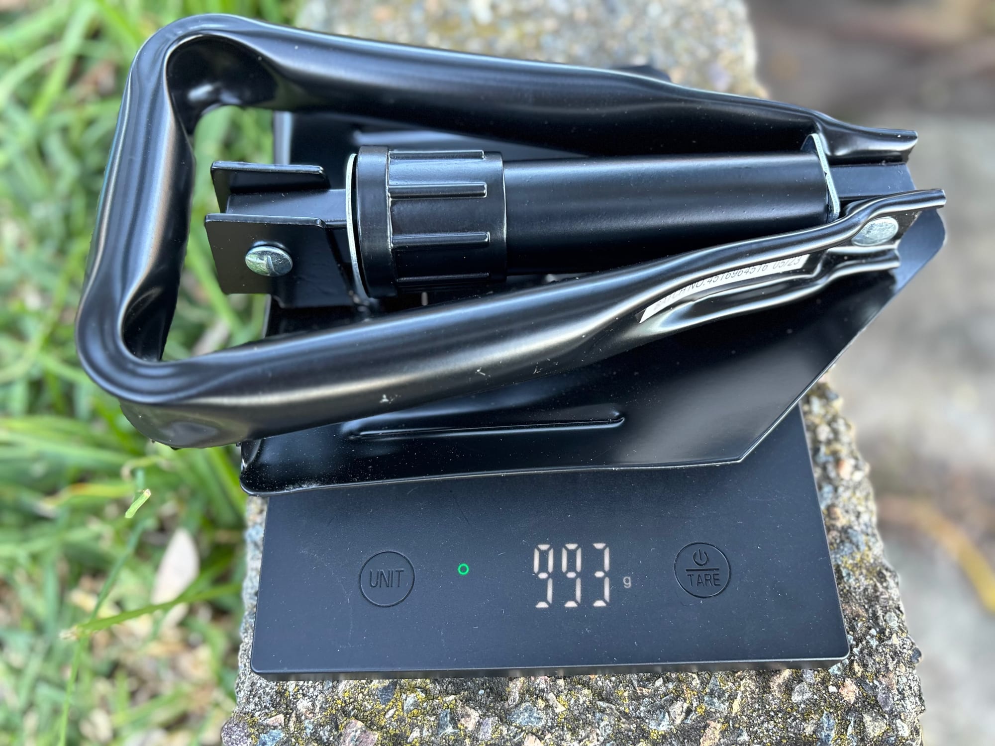 The folded Wanderer shovel on our scale, showing 993 g