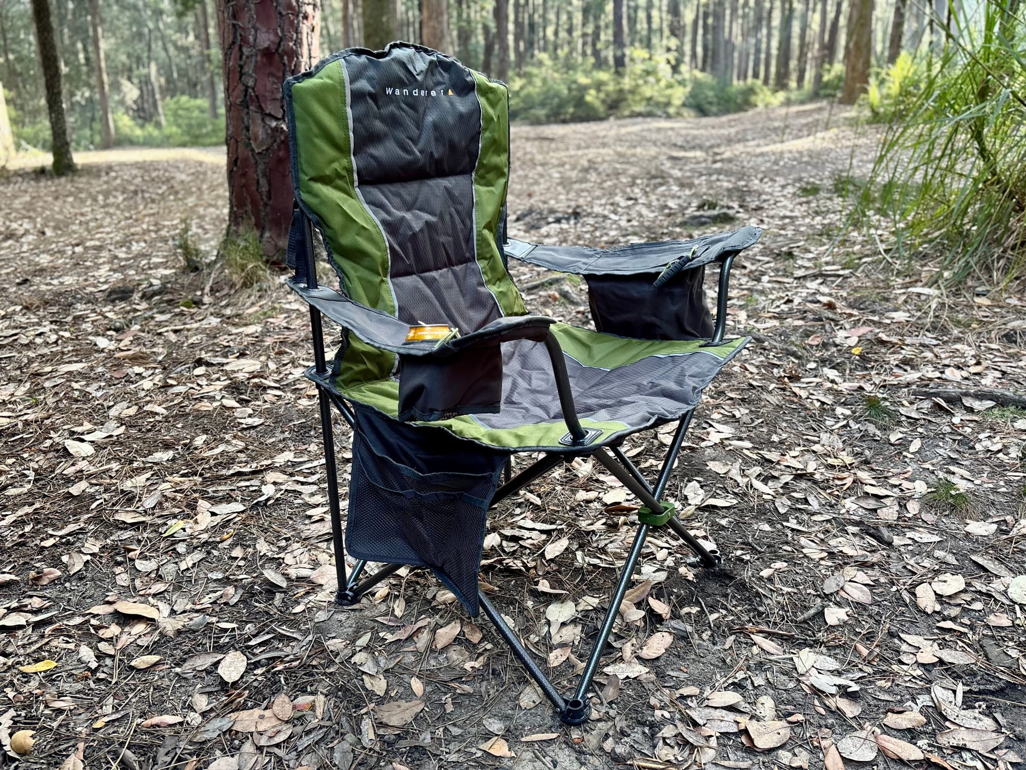 Wanderer Premium Cooler Arm Chair in olive green, set up among the pines at The Pines campground