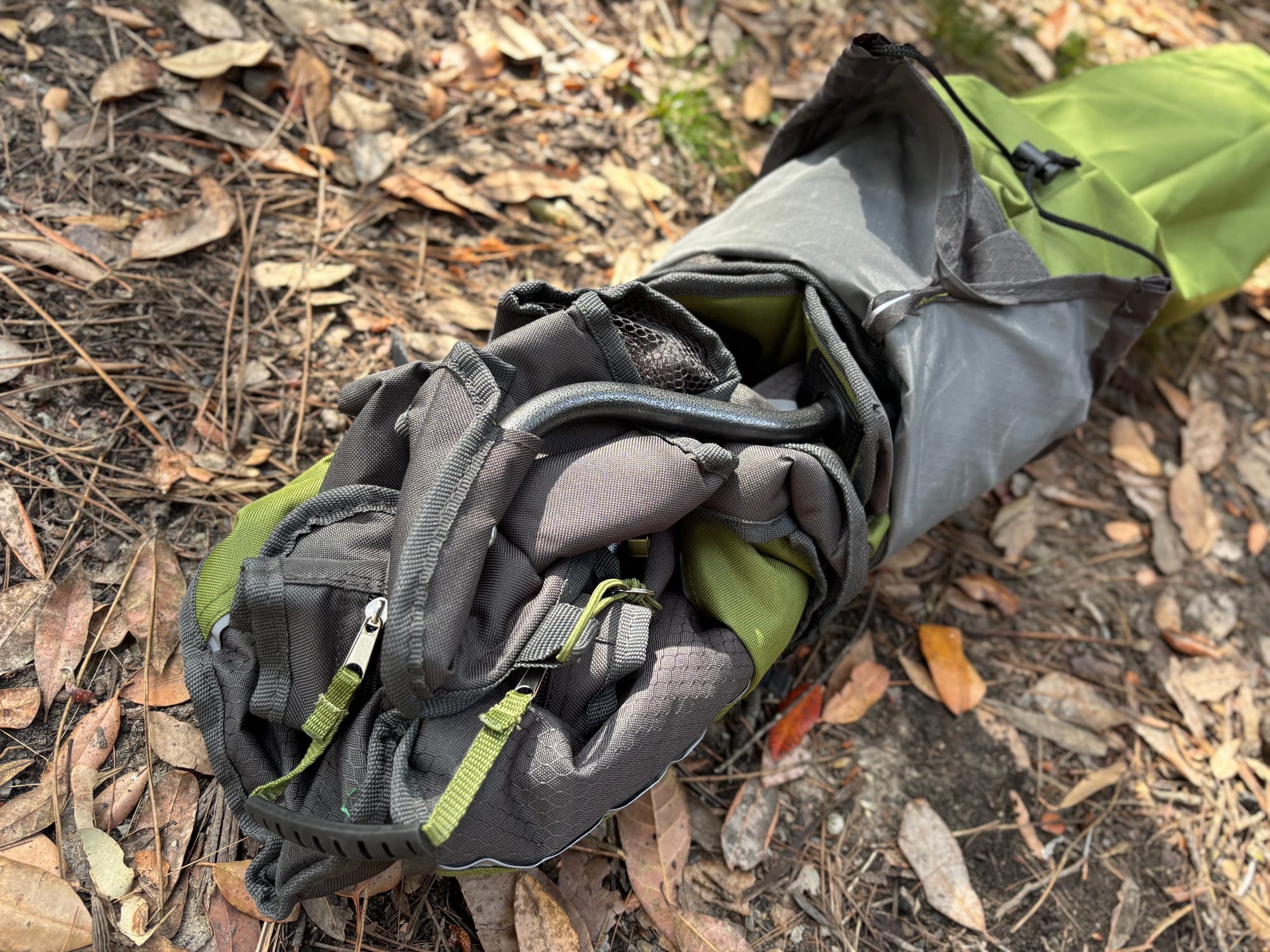 The folded Wanderer Premium chair half out of its bag, with the cooler arm tucked in