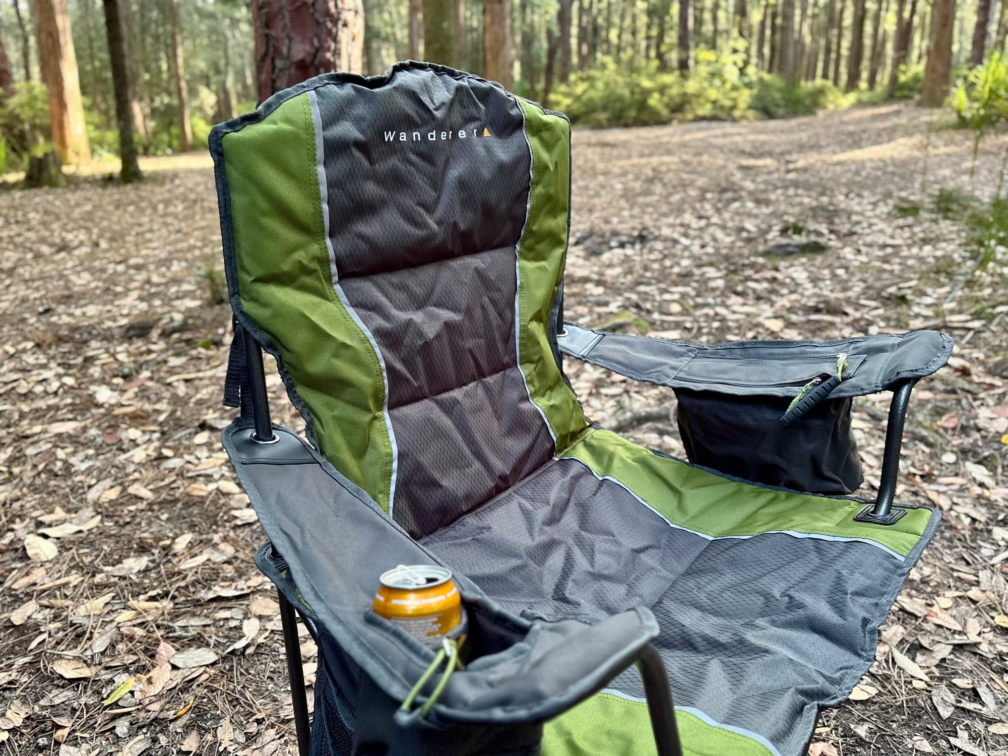 The padded seat and high back of the Wanderer Premium chair, with a can in the drink holder