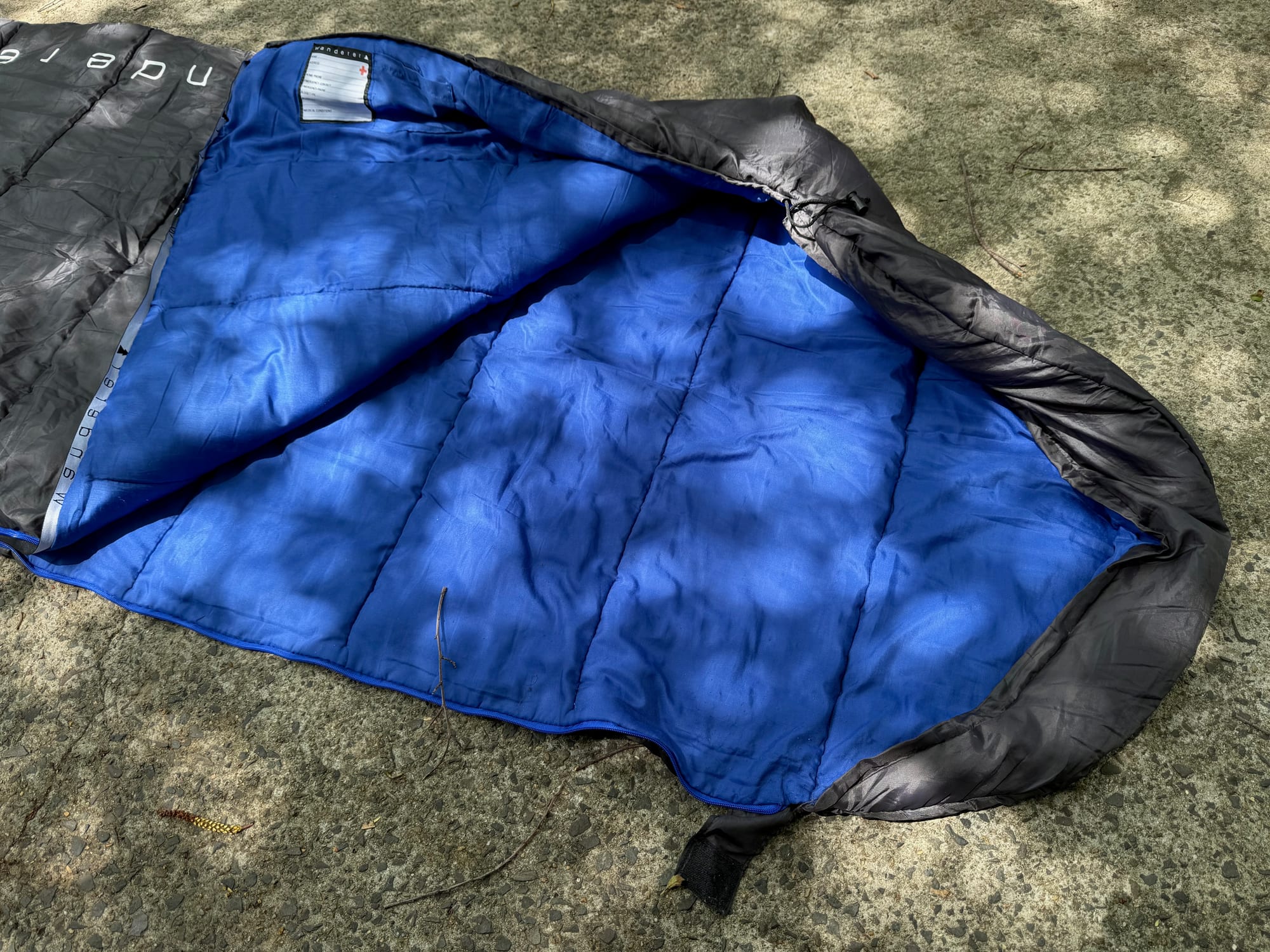 The Wanderer sleeping bag unzipped, showing the blue polyester lining