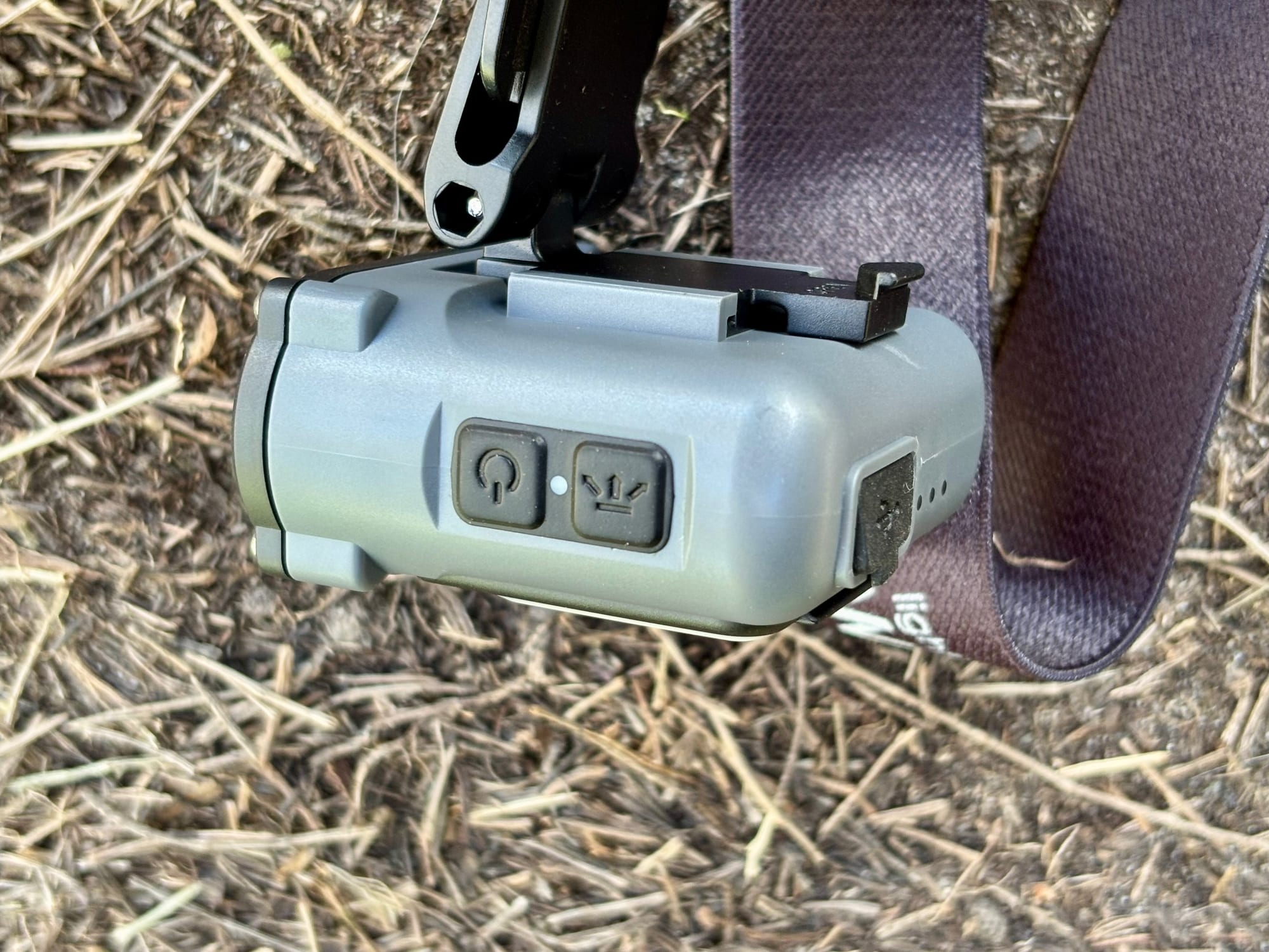 The power button and the sensor button on the side of the Warsun headlamp