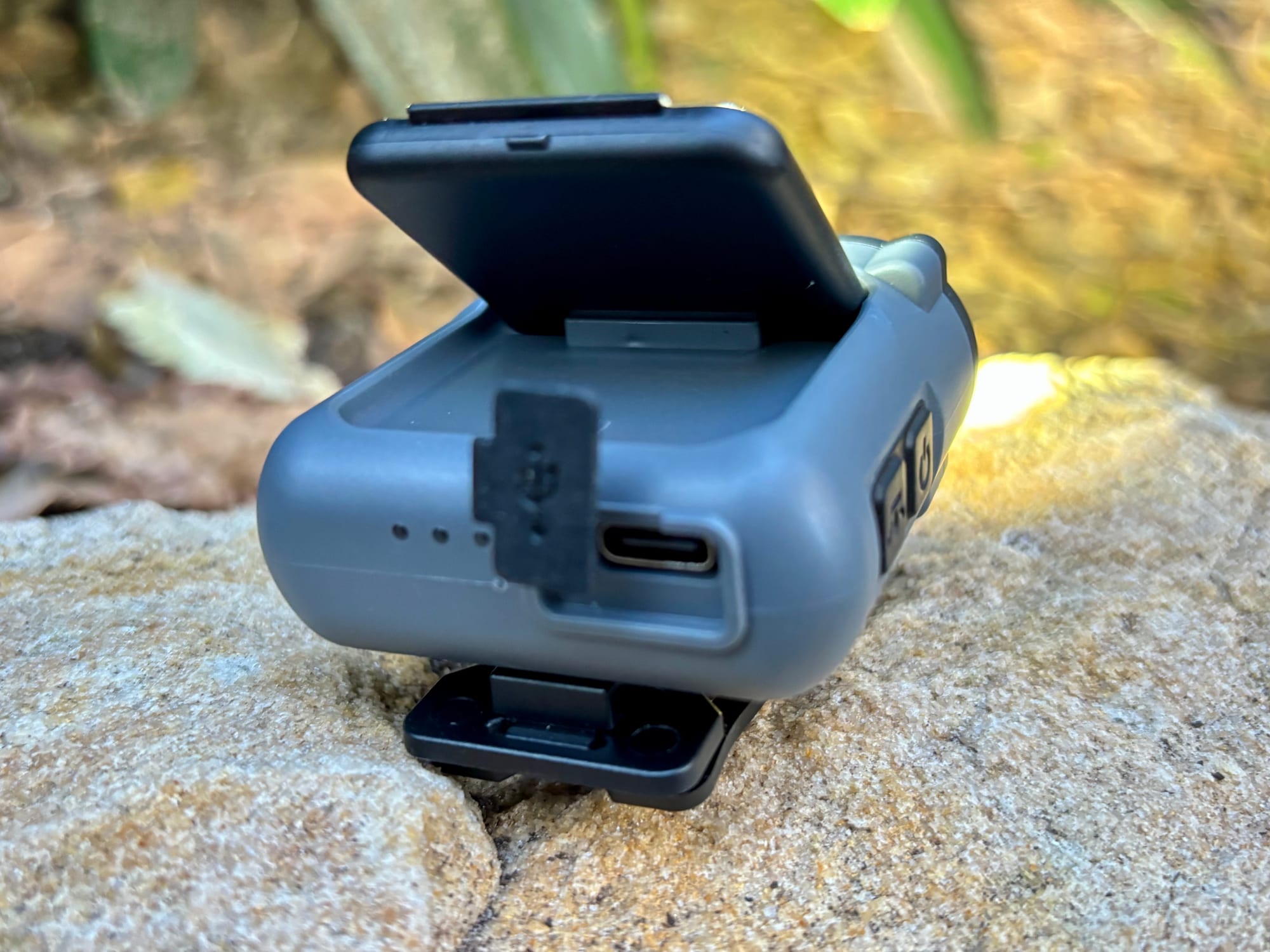 The USB-C charging port of the Warsun headlamp with its rubber cover open