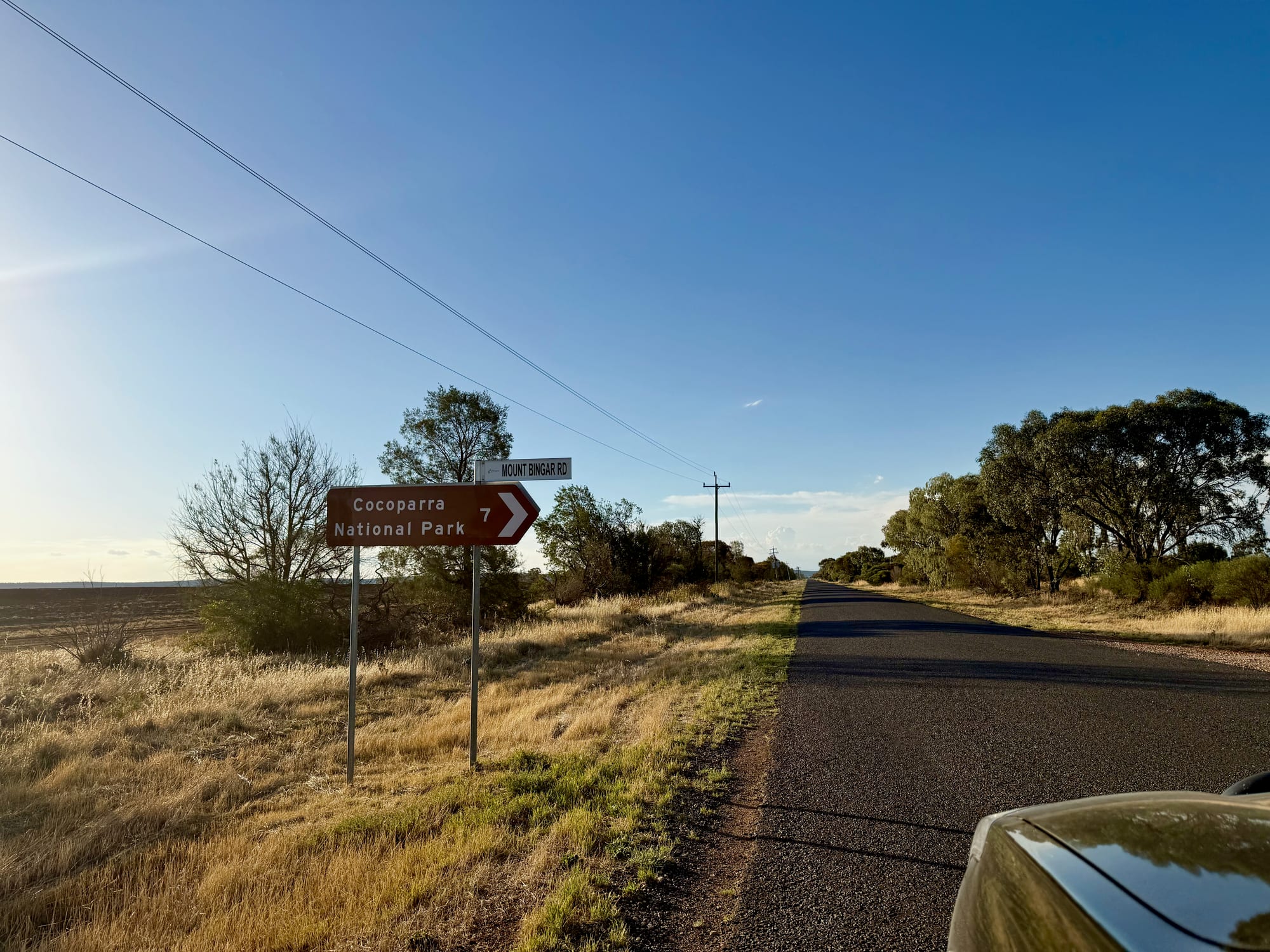 The brown tourist sign for Cocoparra National Park at the turn-off from the sealed road