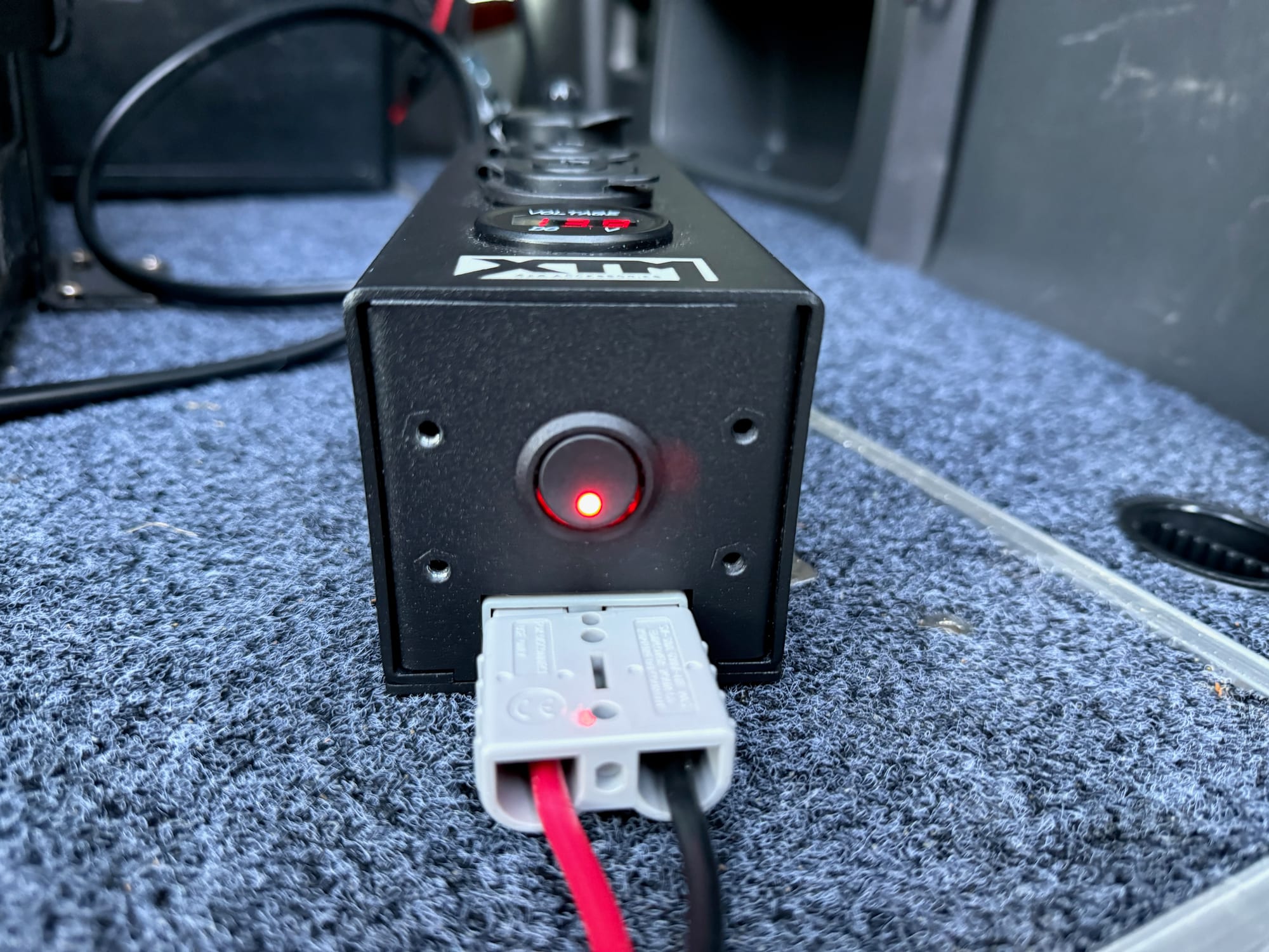 The Anderson plug and the lit rocker switch on the end of the XTM Distribution Panel