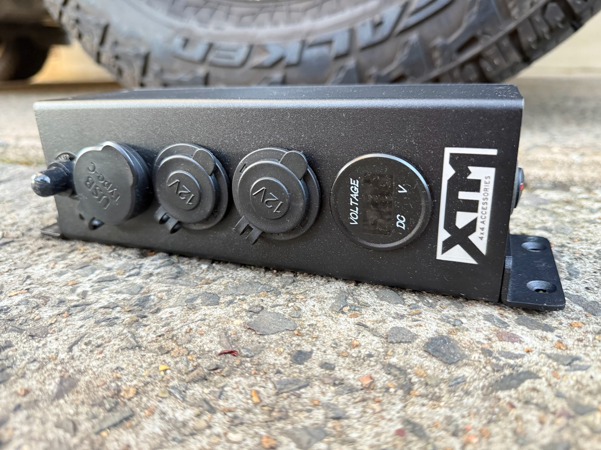 The front of the XTM 12V/24V Distribution Panel, with its sockets, voltmeter and mounting brackets