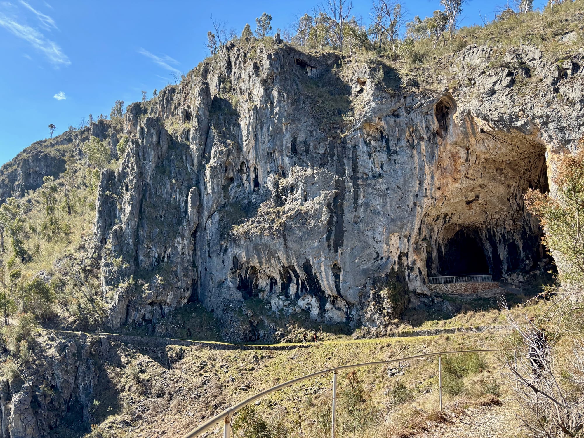 The Glory Arch, a large cave opening in a limestone cliff above the river valley