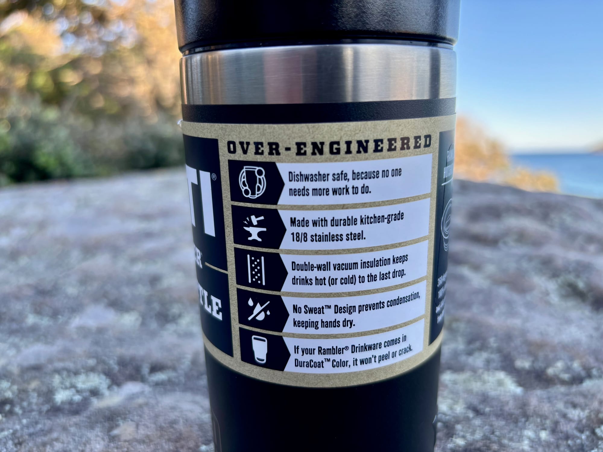 The feature label on the YETI Rambler 12 oz bottle: dishwasher safe, stainless steel, vacuum insulation, DuraCoat