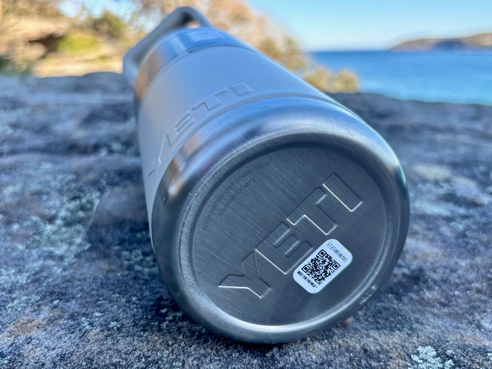 The stainless steel base of the bottle, stamped with the YETI logo and “dishwasher safe”