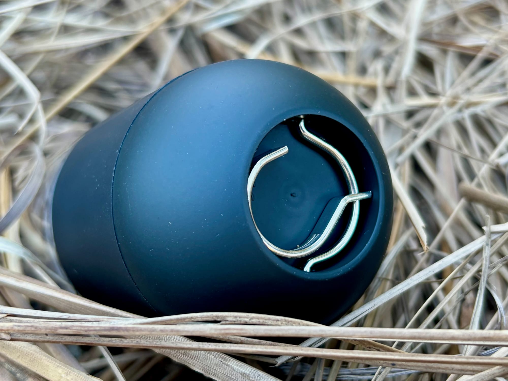 The base of the Zempire Capsule Light with the metal hook folded into its recess