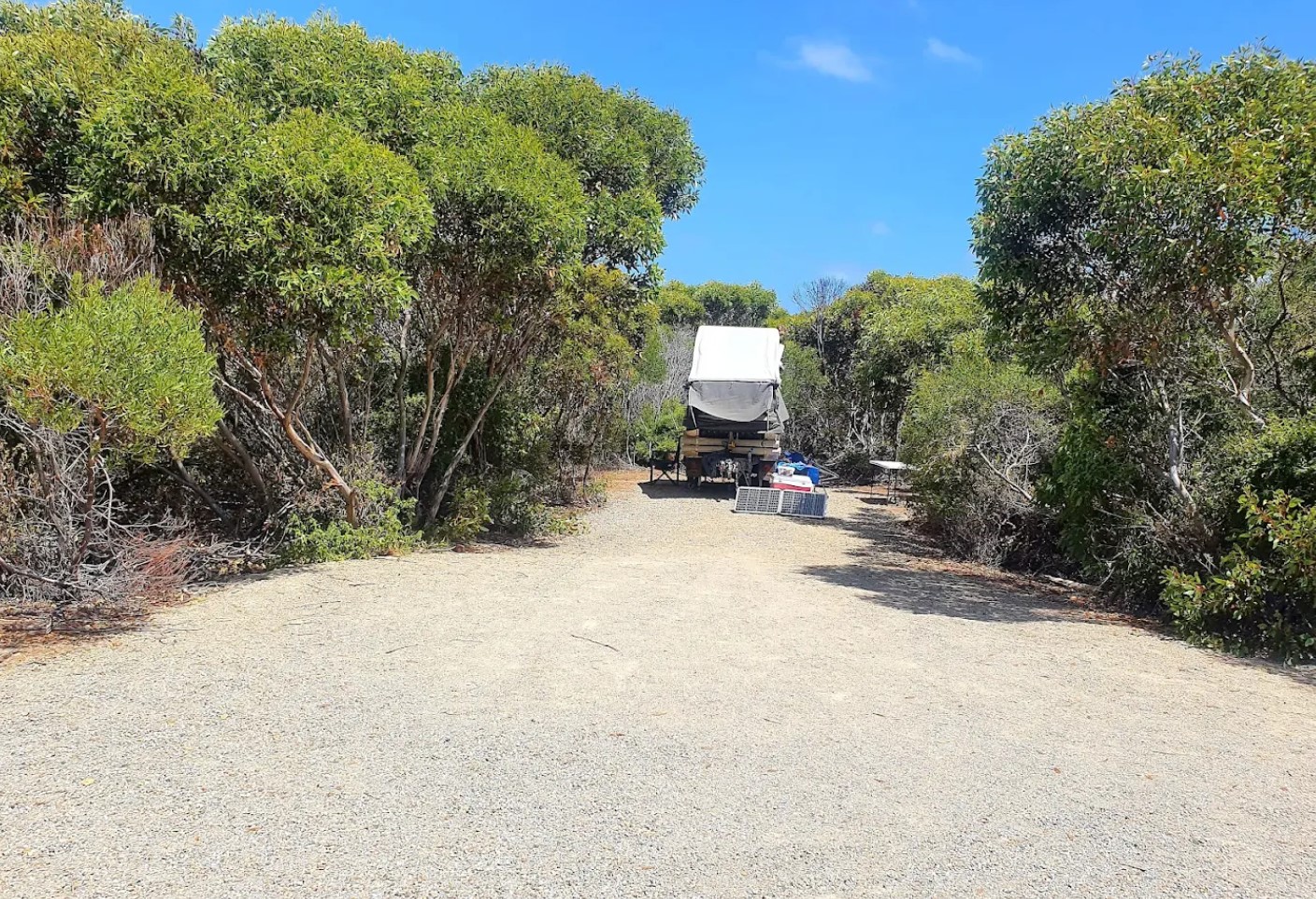 A caravan on one of the camping spots along the gravel loop at Four Mile Campground