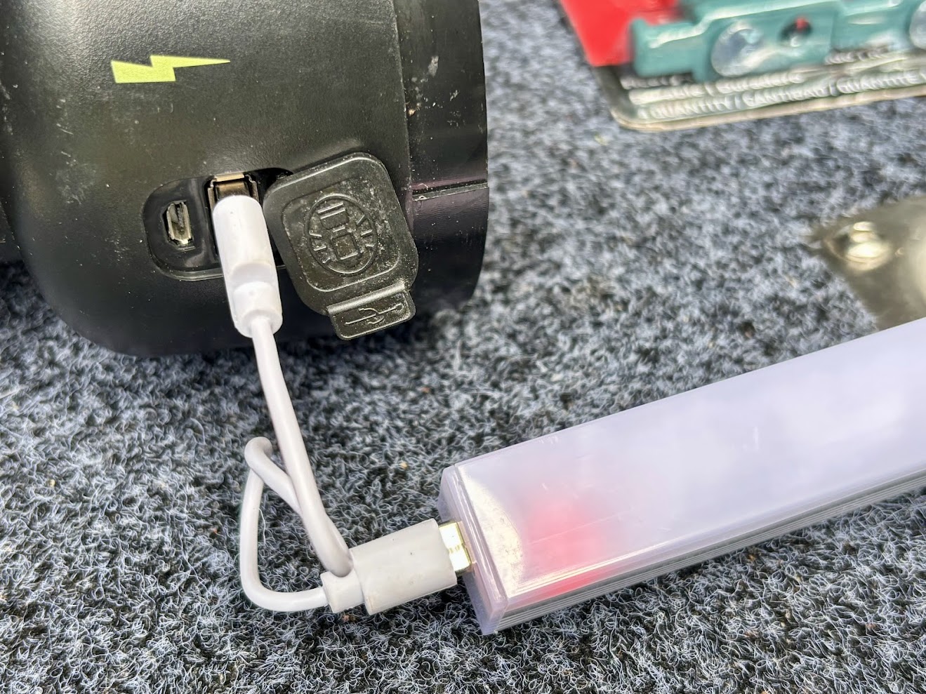 A cable running from the Coleman lantern to a Kings light bar on the rear door