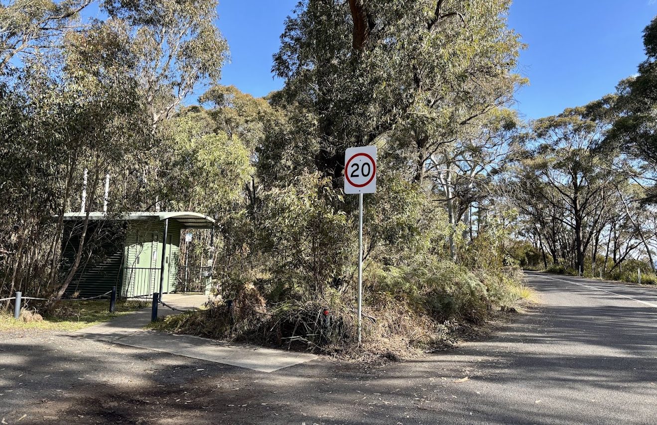 The green pit toilet at Mount York Campground among the trees