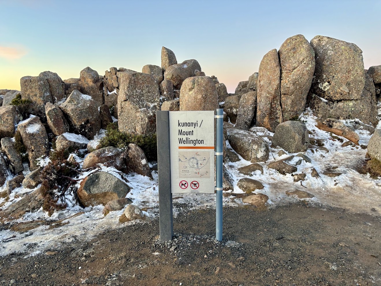 The kunanyi / Mount Wellington sign among the boulders at the summit