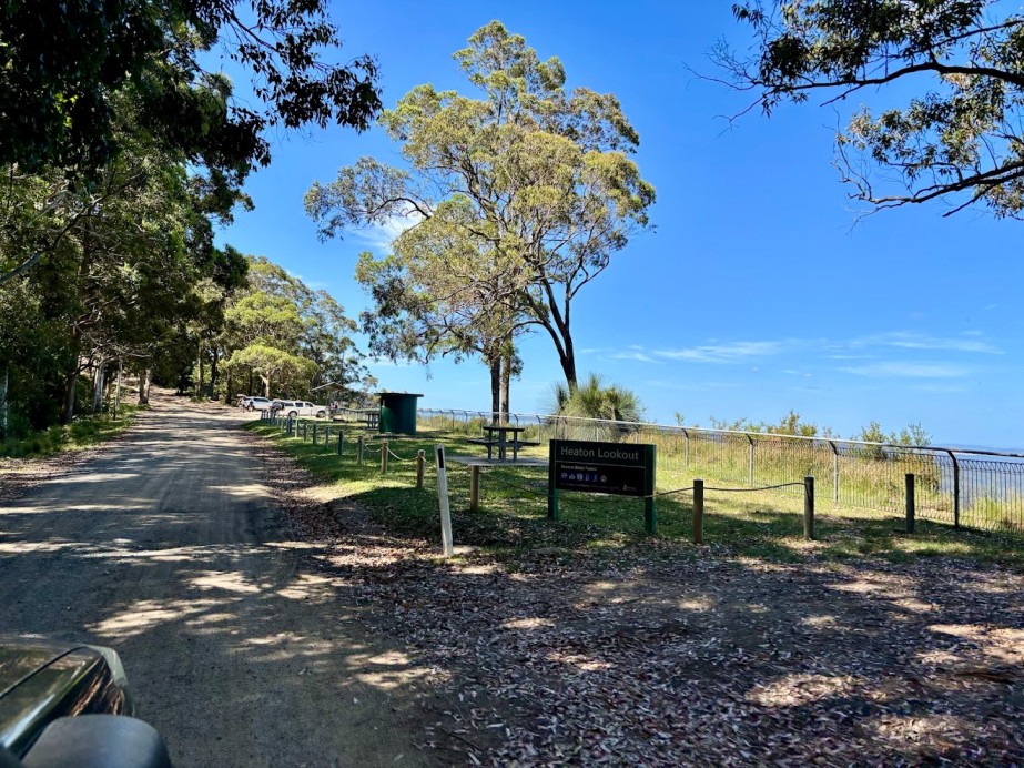 Picnic benches and a fire pit under the trees at Heaton Picnic Area