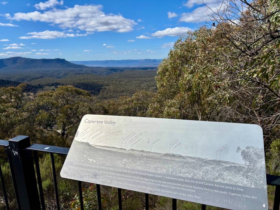 The information plaque on the railing at Pearsons Lookout, with the valley behind